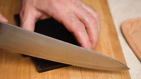 Chef chops small pieces chocolate by knife, cooking with chocolate, sweet pastry Stock Footage 126117529