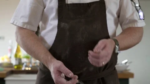 Chef clapping flour off his hands Stock Footage 77081853