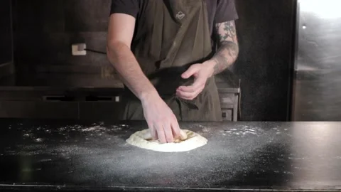 Chef clapping hands with flour and picking up a dough in slow motion Stock Footage 153383478