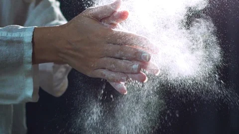 Chef clapping his hands filled with flour. Slow Motion Stock-Footage 96399403
