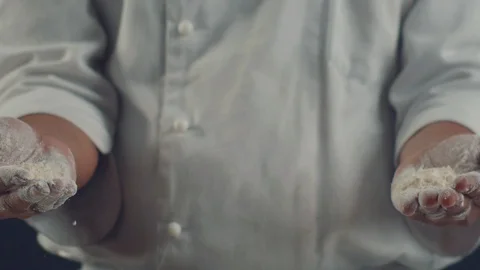 Chef clapping his hands filled with flour. Video slow motion 4K Stock Footage 105096446