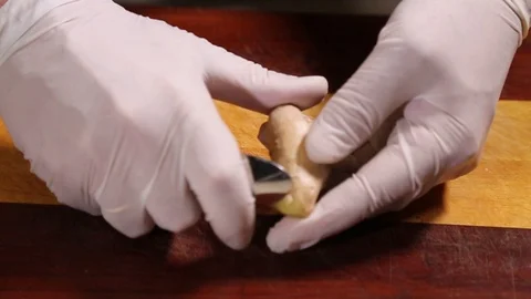 Chef clean the ginger root with a teaspoon Stock Footage 102217134