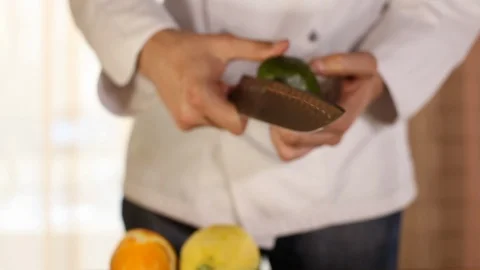 The chef is cleaning the avocado with a knife.close-up Stock Footage 115658845