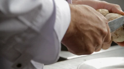 Chef Cleaning Big Mushroom with Knife on Bright Light Stock Footage 110478366