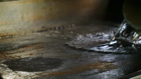 Chef is cleaning the grill in the kitchen in a restaurant. 스톡 동영상 119093328