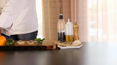The chef is cleaning the mango with a knife.there's an orange on the table, an Stock Footage 115478232