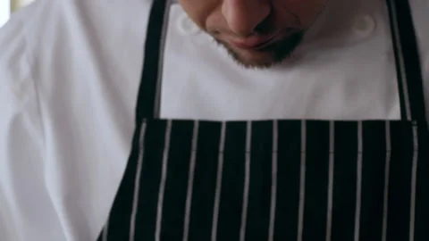 Chef cleaning walnut with a knife in interior kitchen with soft day lighting. Cl Video stock 199455724