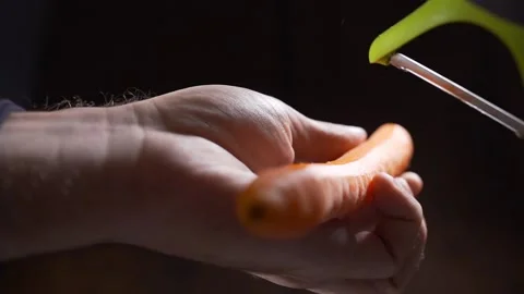 Chef cleans the carrot in the kitchen close up Stock Footage 143776901