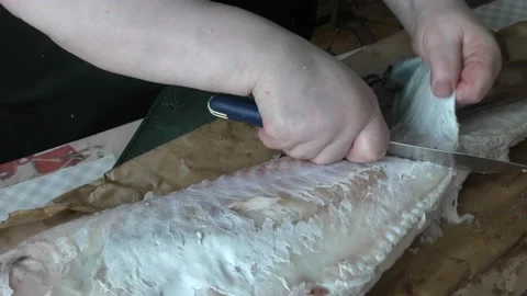 Chef cleans cod fish with a knife Stock Footage 172360932