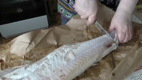 Chef cleans cod fish with a knife Stock Footage 197929420