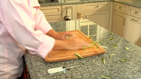 Chef cleans up peels skin and refuse after cooking in kitchen Stock Footage 123732804