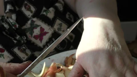 Chef cleans raw potatoes with a knife Stock Footage 197546220