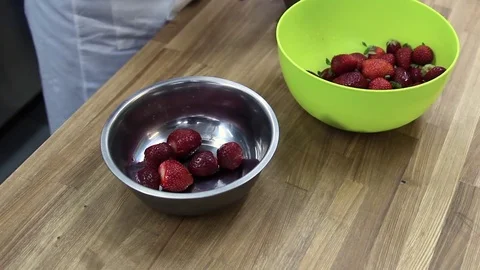 Chef cleans strawberries from tails Video stock 69993473
