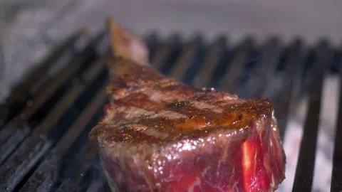Chef close-up of tomahawk fried steak with smoke. Stock Footage 154892903