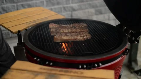 Chef closes the lid of the grill when meet was cooking Stock Footage 208121044