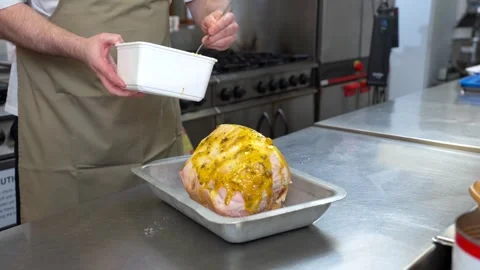 Chef Coating Ham with Marinade in Professional Kitchen Stock-Footage 321366586