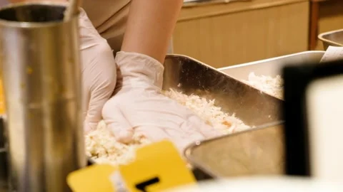 Chef coating pork meat in bread crumbs to make fried pork cutlet Stock Footage 133214428