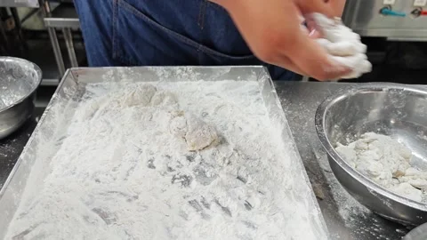 Chef coating raw fish with white flour on a tray. Stock Footage 342739776