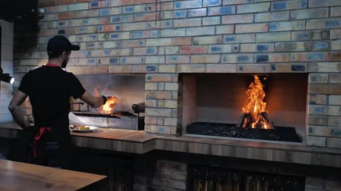 The chef cocking a juicy grilled meat steak with an open flame. T-bon. Stock Footage 202008955