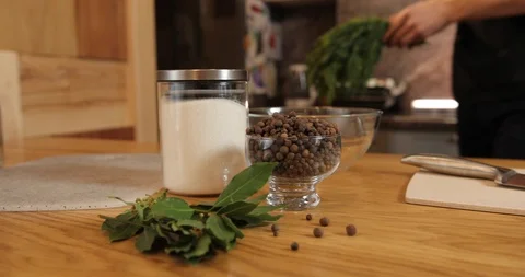 The chef coming to the table and puts the dill on the cutting board. on the Stock Footage 126151867