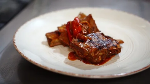 Chef cook arranging fried meat meal presentation putting hot tomato ragout sauce Stock Footage 106979353