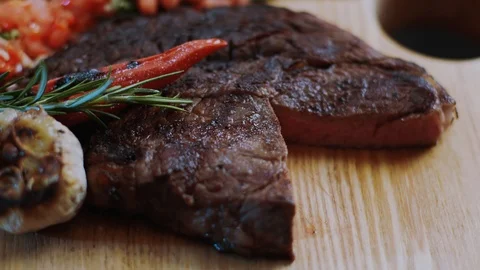 Chef cook beef steak medium well cut sliced knife on a cutting board roast Stock Footage 100304994