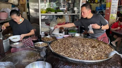 Chef cook in a big pan of stewed meat in Bangkok, Thailand 4K Stock Footage 244704130