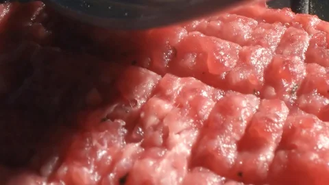 Chef cook in black gloves forms a cutlet for cooking with a fork on the cutlet Stock Footage 115774849