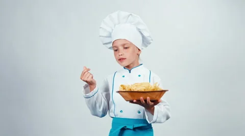 Chef cook child 7-8 years holds plate with pasta and dancing isolated on white Stock Footage 67169239