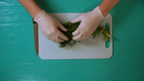 Chef cook cutting dill on a white board Stock Footage 113462409
