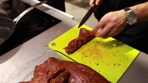 Chef cook cutting meat for steaks on board Stock Footage 115286965