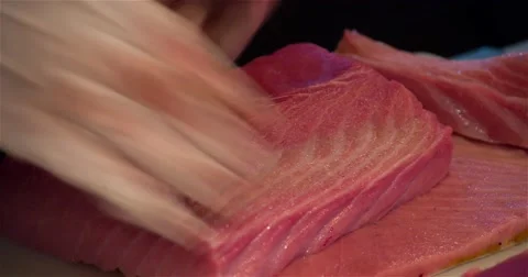 Chef cook cutting raw tuna fish 4k video in sushi restaurant. Japanese cuisine Stock Footage 67487812