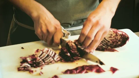 Chef cook cutting red cabbage vegetables with big sharp knife in kitchen Stock Footage 103853428