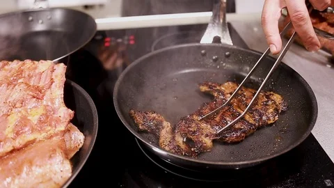 Chef cook fried meat steak in pan Stock Footage 113016632