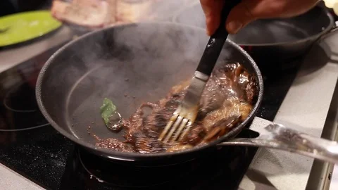 Chef cook fried meat steak in pan Stock Footage 113016642