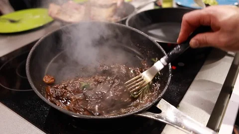 Chef cook fried meat steak in pan Stock Footage 113016660