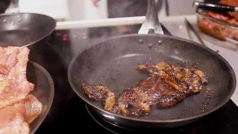 Chef cook fried meat steak in pan Stock Footage 115286441