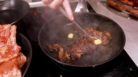 Chef cook fried meat steak in pan, steam from the dish Stock Footage 115286521