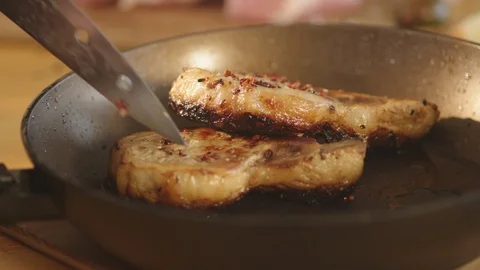 Chef cook fried meat steak in pan Stock Footage 125168006