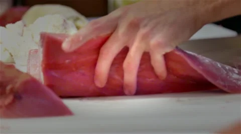 Chef cook hands cutting with knife tuna fish fillet 4k close up video Stock Footage 67487878