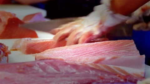 Chef cook hands knife cutting tuna fish fillet 4k video. Sushi Japanese cuisine. Stock Footage 67487869