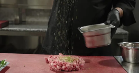 Chef cook pours chopped pistachios on minced meat. Kebab preparation. Turkish Stock Footage 259339199