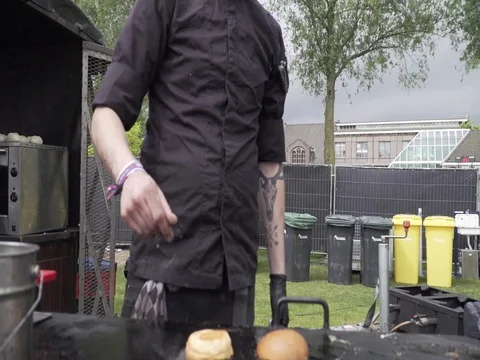 Chef-cook-prepares-grill-plate-with-bacon-eggs-bun Stock Footage 78609918