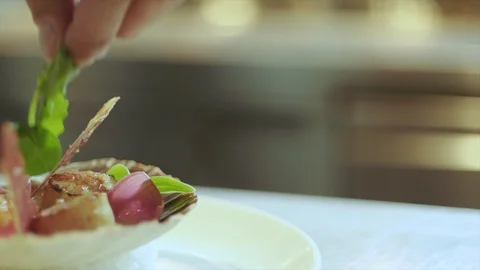 Chef cook preparing and finishing desert with green leaf topping in kitchen Stock Footage 103850340