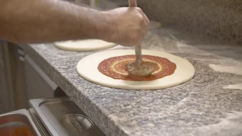 Chef cook preparing pizza dough with tomato sauce 4k Stock Footage 253413917