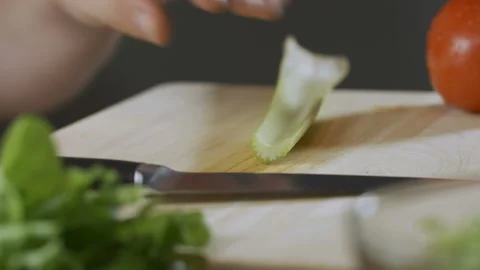Chef cook professionally cutts celery on cutting board Stock Footage 90800773