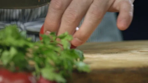 Chef cook professionally cutts tomatoes with a chef's knife on cutting board Stock Footage 76957823
