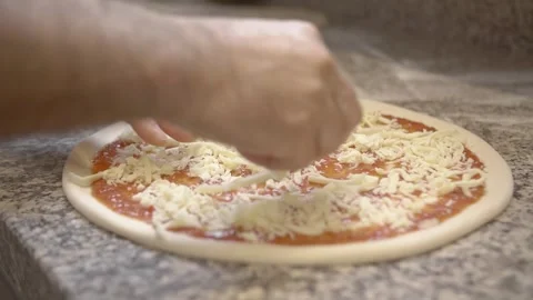 Chef cook puting cheese on pizza dough in restaurant 4k Stock Footage 253480269