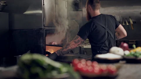 Chef cook putting raw steak in the restaraunt grill. Stock Footage 151469659
