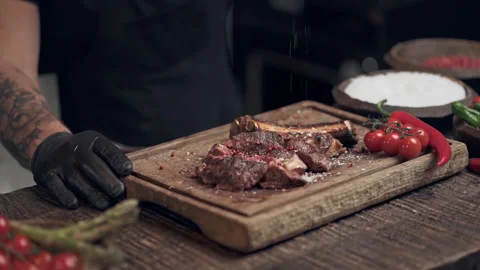 Chef cook sprinkle black pepper on the meat. Slowmotion. Stock Footage 151469878